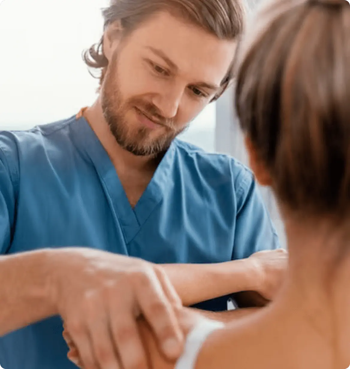 A healthcare professional listening to a patient during a consultation